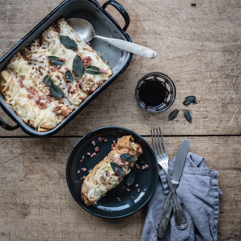 Rezeptbild: speckbutter crespelle, gefüllt mit wirsing, speck, apfel und mit bergkäse im ofen gratiniert