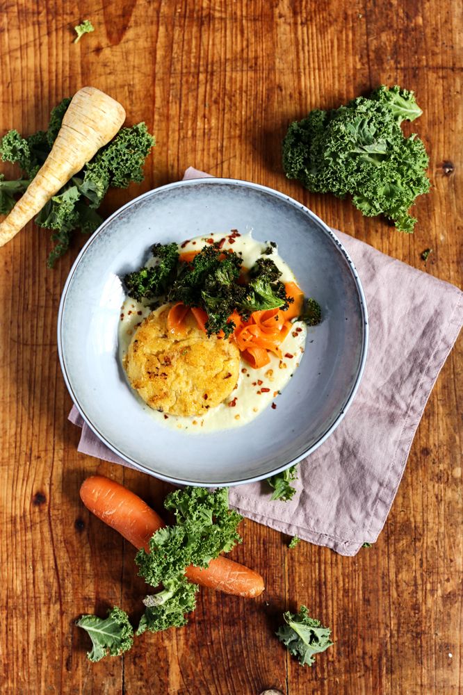 Rezeptbild: GRÜNKOHLCHIPS, KARAMELLISIERTE MÖHREN UND POLENTA-TALER AUF PASTINAKEN-SAUCE